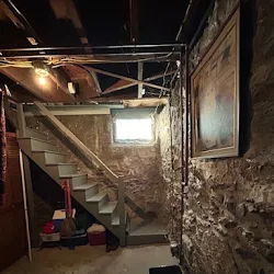 Before: 1908 stone basement parged, new polished slab